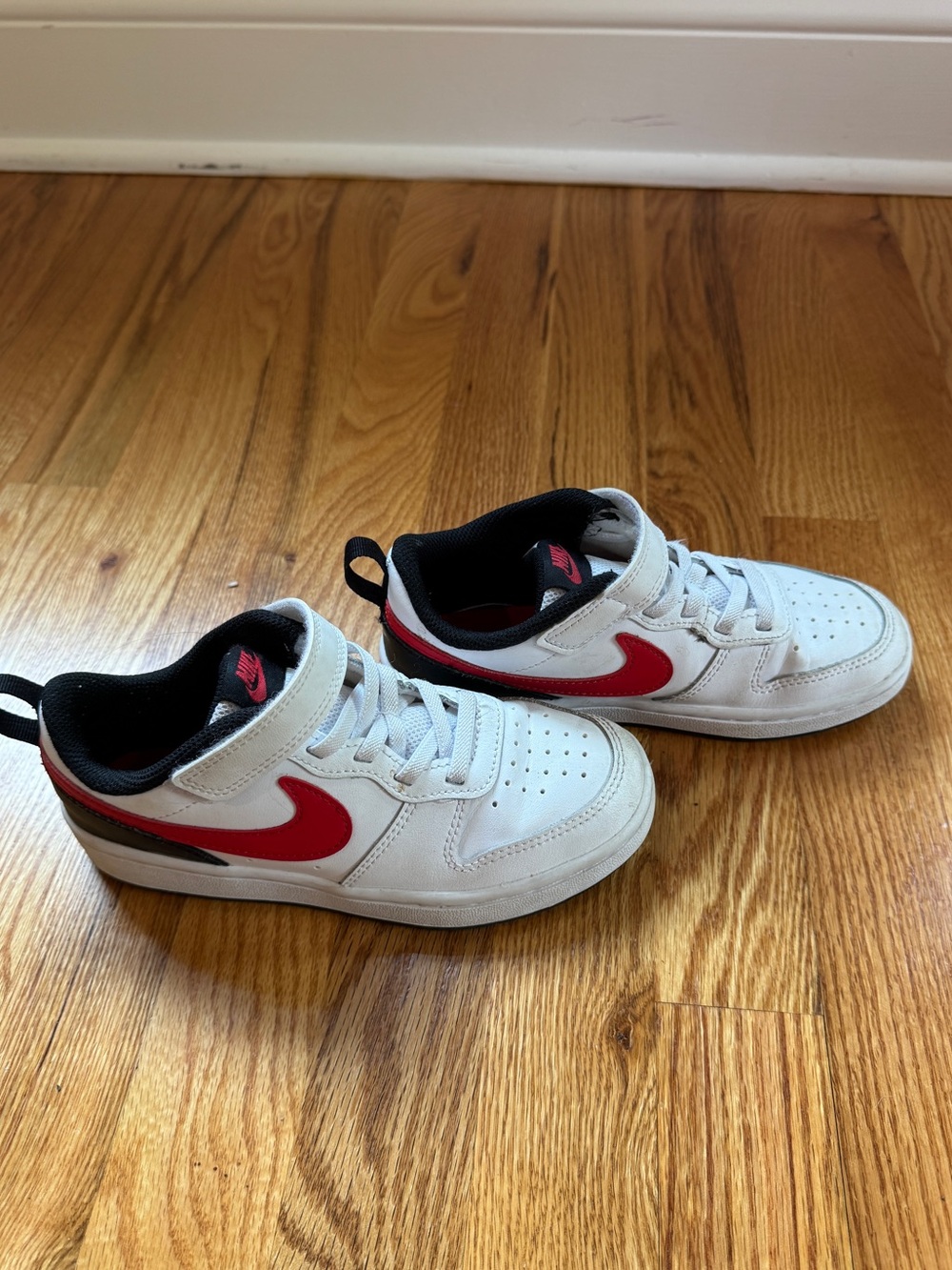 Nike White Low-Top Sneakers with Red Swoosh and Black Trim